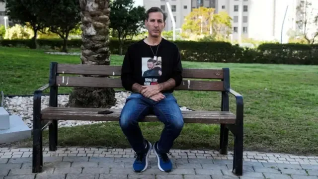 A man sits on a park bench