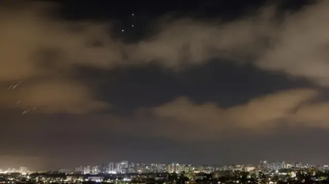 Missiles launched from Iran towards Israel are intercepted, as seen from Ashkelon