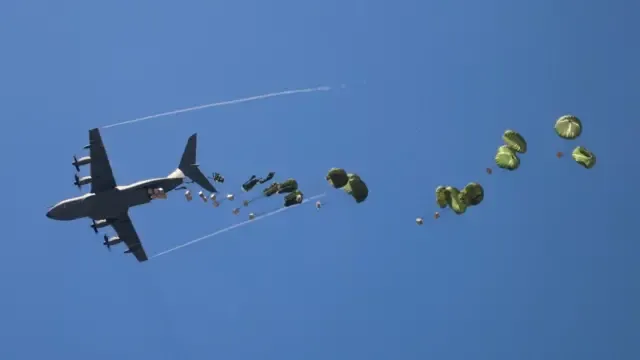 An aircraft drops aid packages
