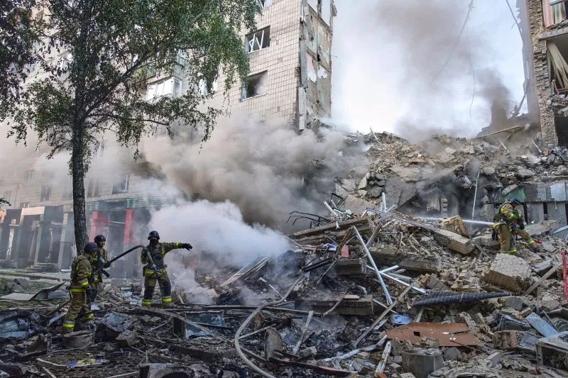 Firefighters put out the fire after a Russian missile hit a residential building in Kyiv, Ukraine, on June 17.