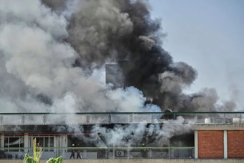 Firefighters work in a building of the Soroka hospital complex in Be'er Sheva, after it was hit by a missile.
