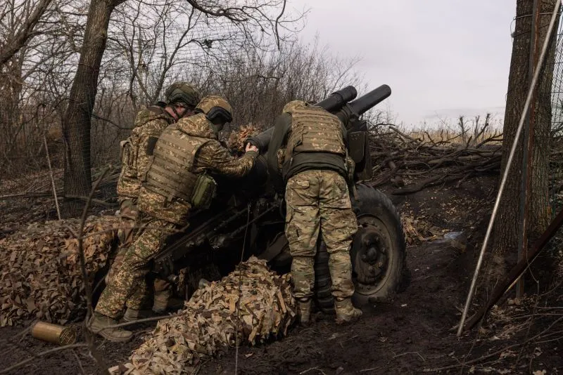 Service members of Ukraine's 13th Brigade Khartiia operate an American supplied M101 howitzer on March 6 in the Kharkiv region of Ukraine.