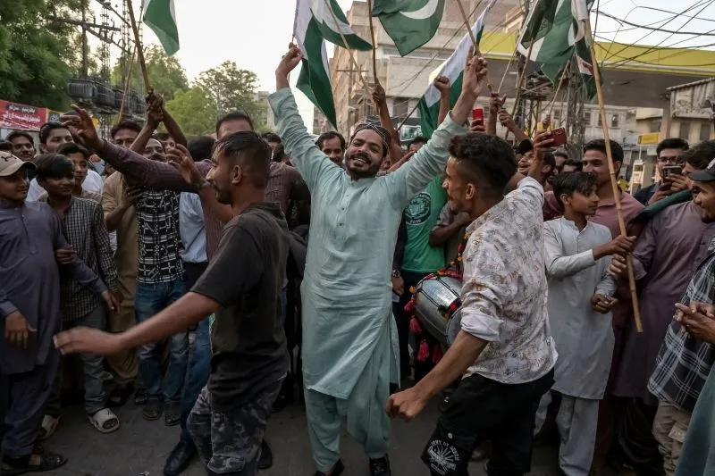 Pakistani people celebrate the ceasefire between Pakistan and India, in Hyderabad, India on Saturday.