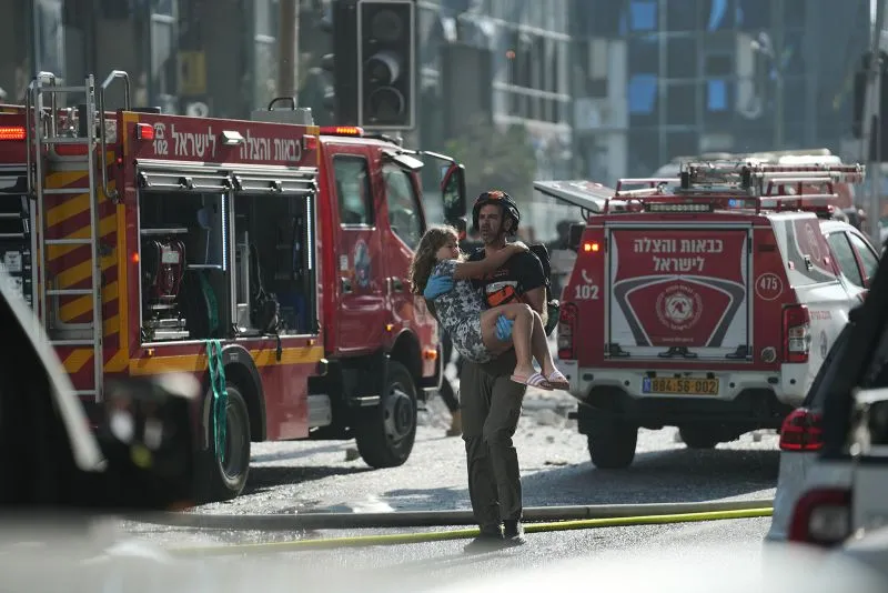 Emergency workers respond to the site of a reported Iranian missile strike in Ramat Gan, Israel on Thursday.