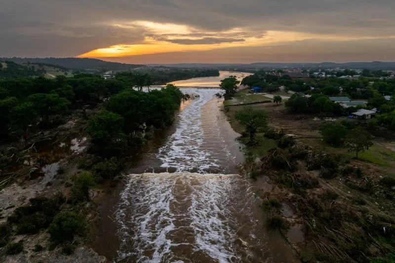 In an aerial view, the sun sets over the Guadalupe River on Sunday.