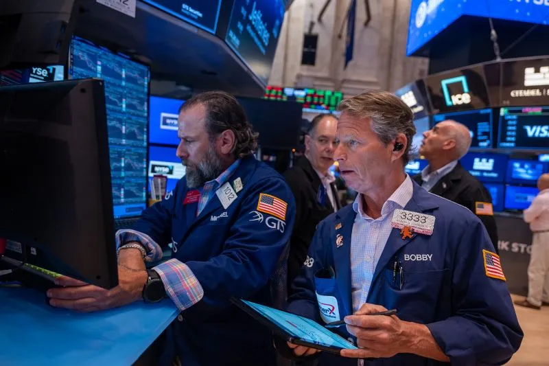Traders work on the floor of the New York Stock Exchange on July 30.