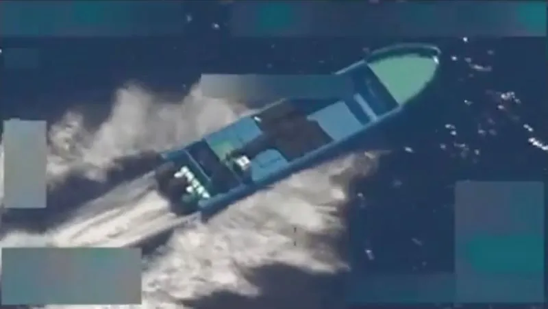 In this screengrab of a video shared by Defense Secretary Pete Hegseth on October 22, 2025, a boat is seen shortly before it is hit by a strike, on October 21, 2025. Hegseth said two people onboard were killed in the strike.