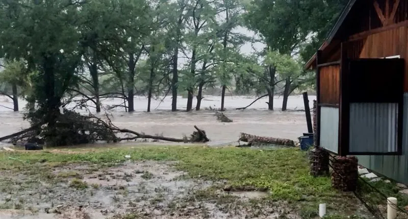 Leigh-Anne Aiken shows the flooded Guadalupe River near her home in Kerr County.