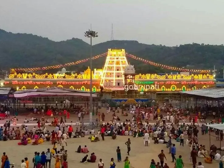 This may contain: many people are standing around in front of a carnival