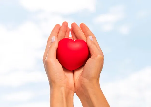Free photo low angle of hands holding heart shape with sky