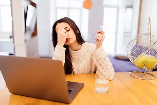 Free photo tired woman is working on her laptop and sitting at home at the wooden table