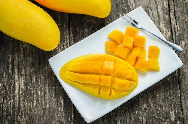Slice of golden mangoes at white dish