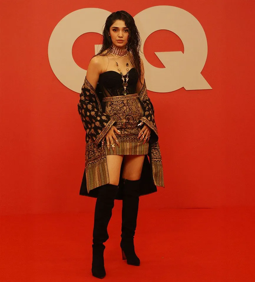 Image may contain Fashion Adult Person Body Part Thigh Clothing Dress Blouse Footwear Shoe High Heel and Standing