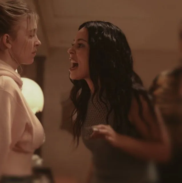 This may contain: two women standing next to each other talking