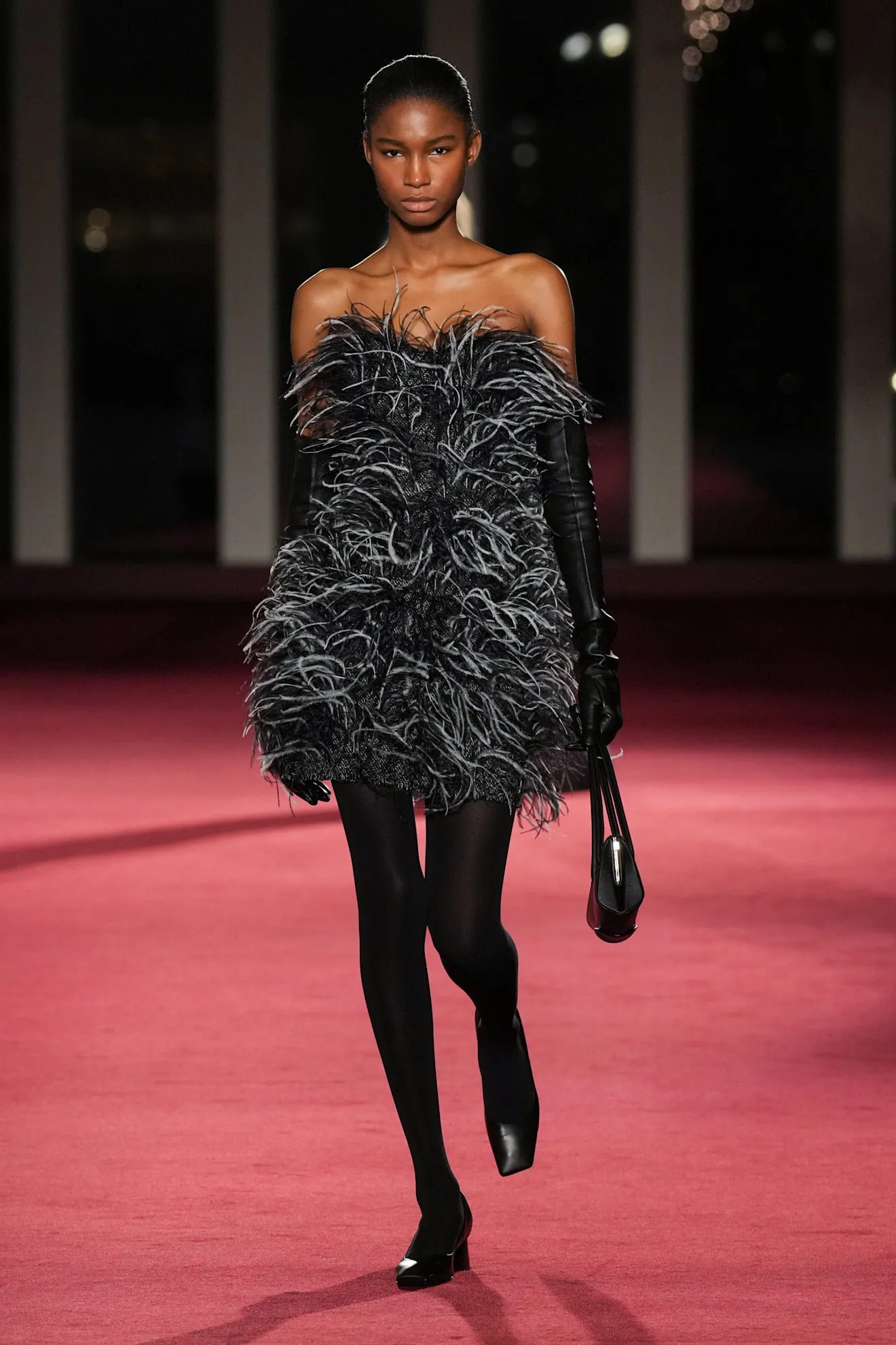 Fashion model showcasing a designer outfit on the runway.