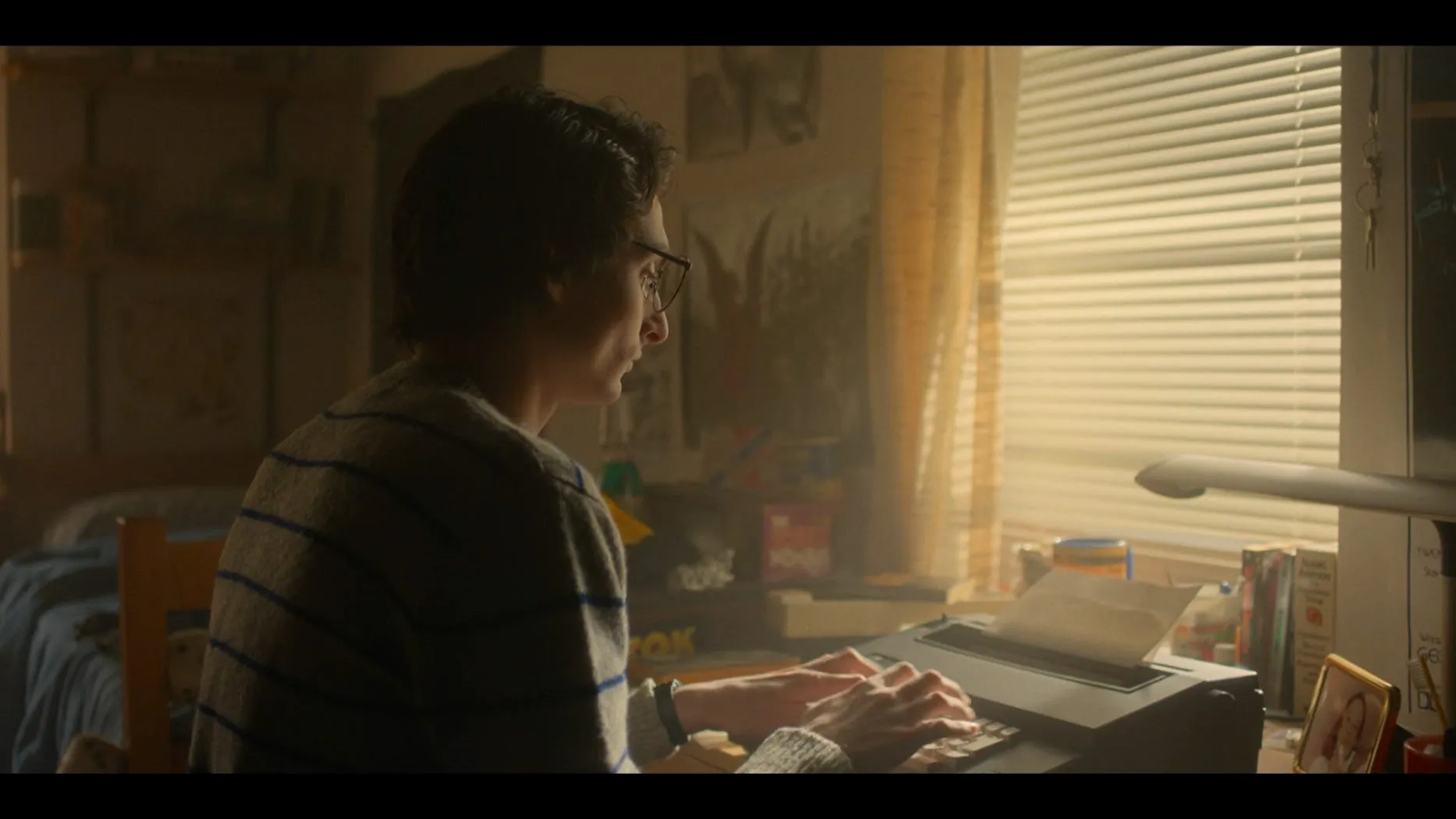 mike using a typewriter in a bedroom in stranger things season 5 episode 8