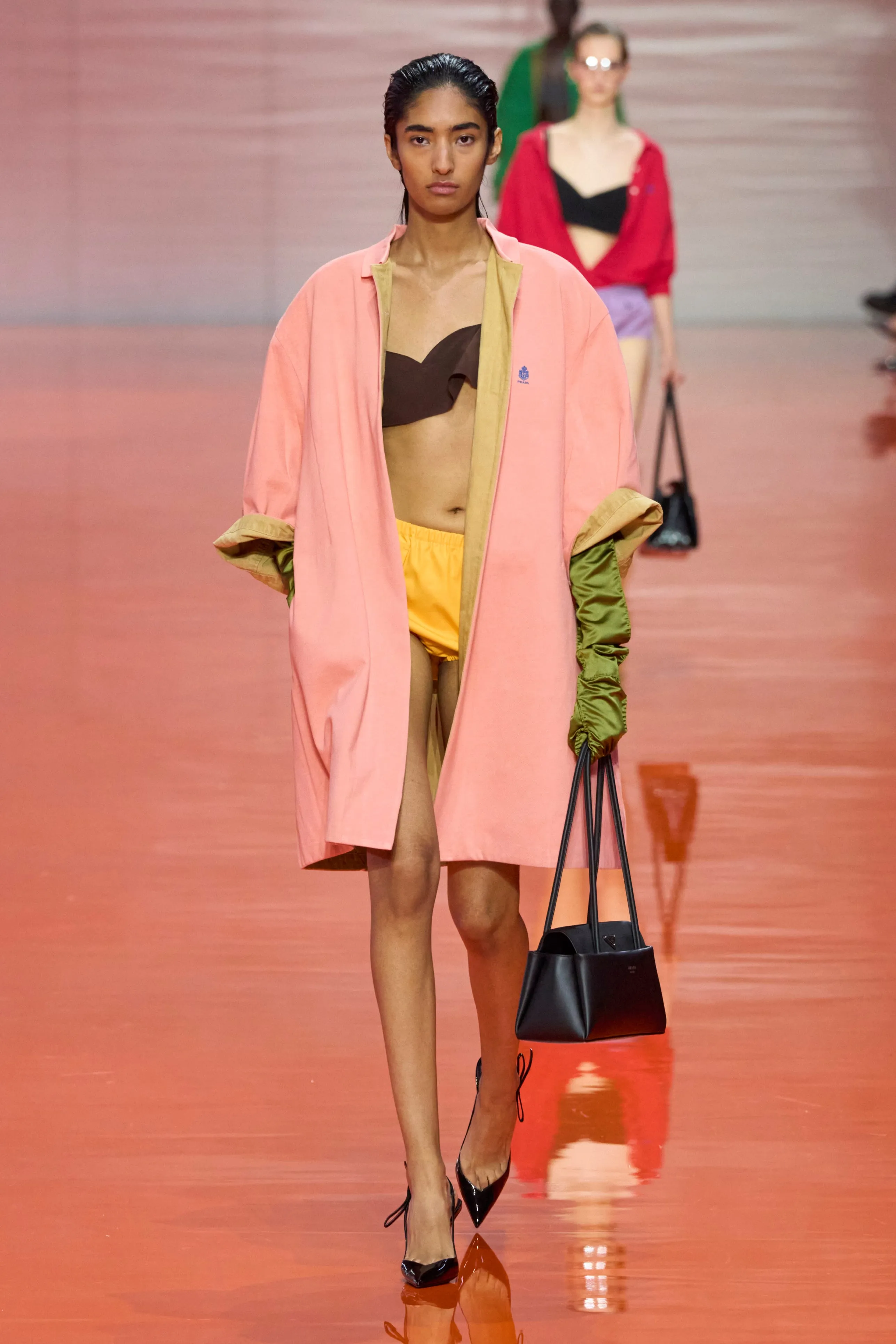 fashion model walking on the runway in a vibrant outfit
