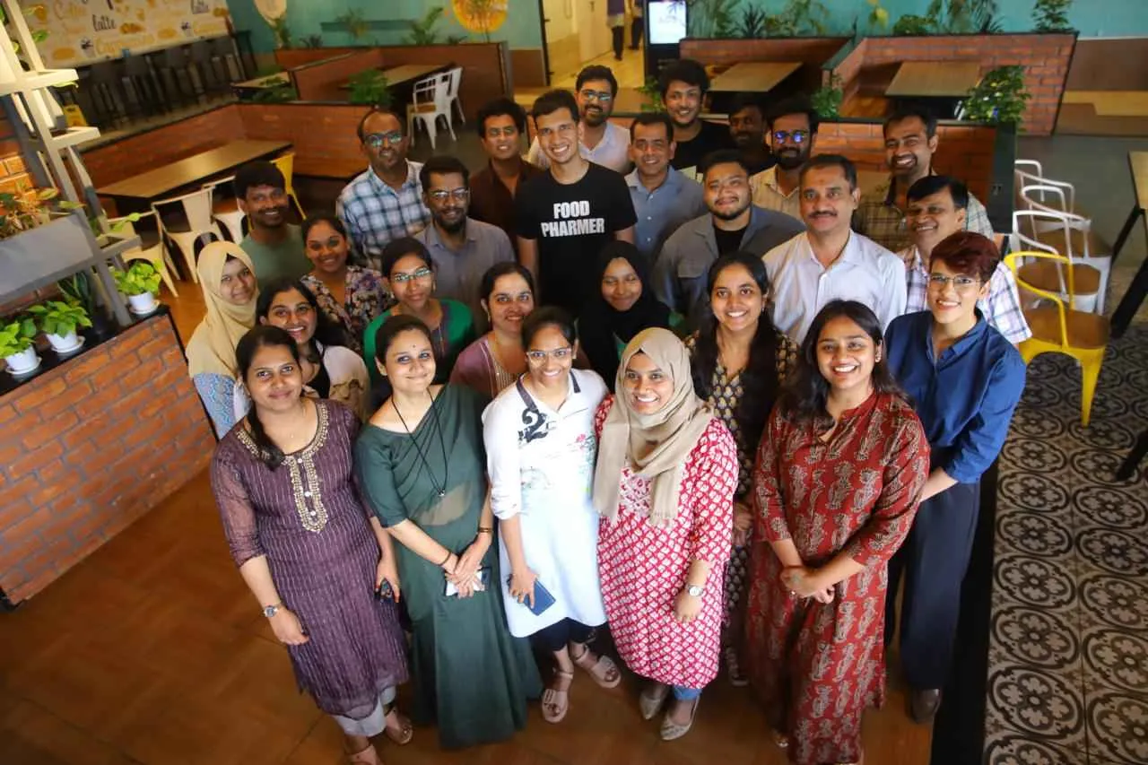 Founders Ravi Teja Putrevu and Dr Aman Basheer Sheikh with the TruthIn team, posing together in an office setting.