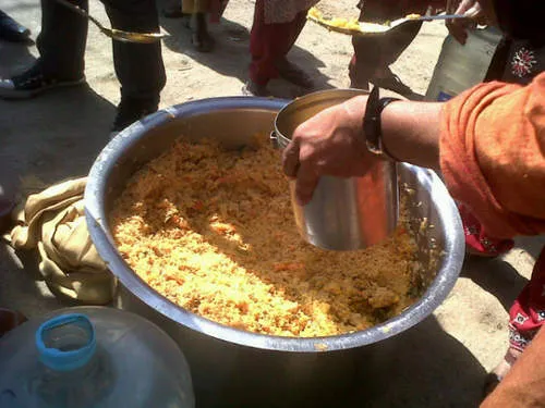 Distributing food at slum demolition site. 