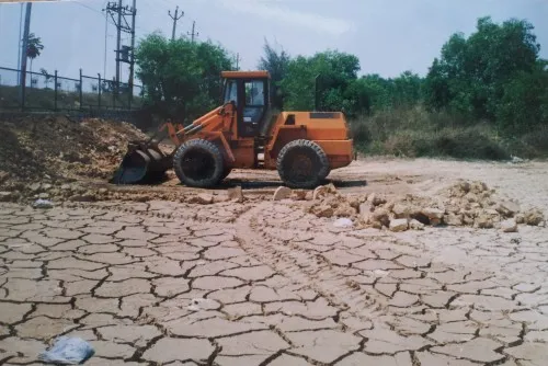 The restoration work begins. The parched and cracking lake bed is plain to see.