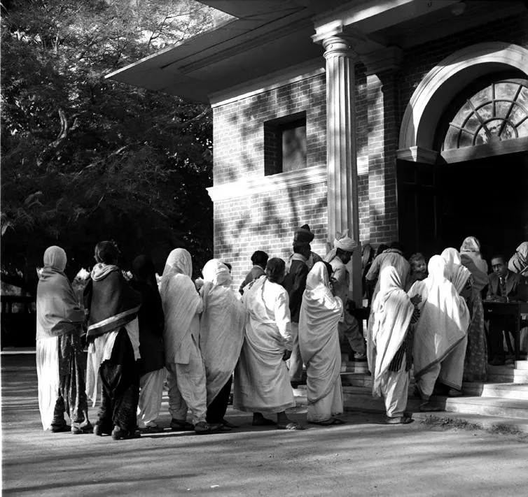 A view of Polling Booth at Modern High School, in New Delhi. A long queue of women voters are seen waiting for their turn to cast their votes.