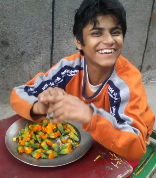 Sapna, one of the young adults at Society for Child Development, works with flowers 