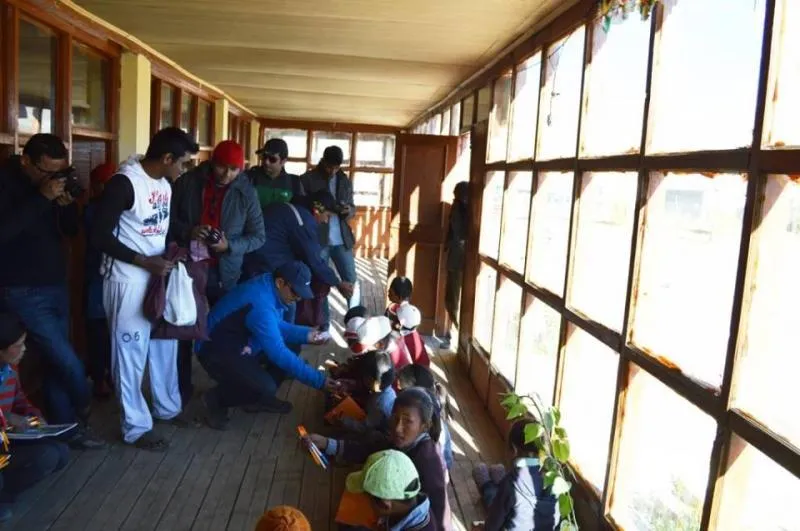 The team distributes stationary items to the local schools in the hills.
