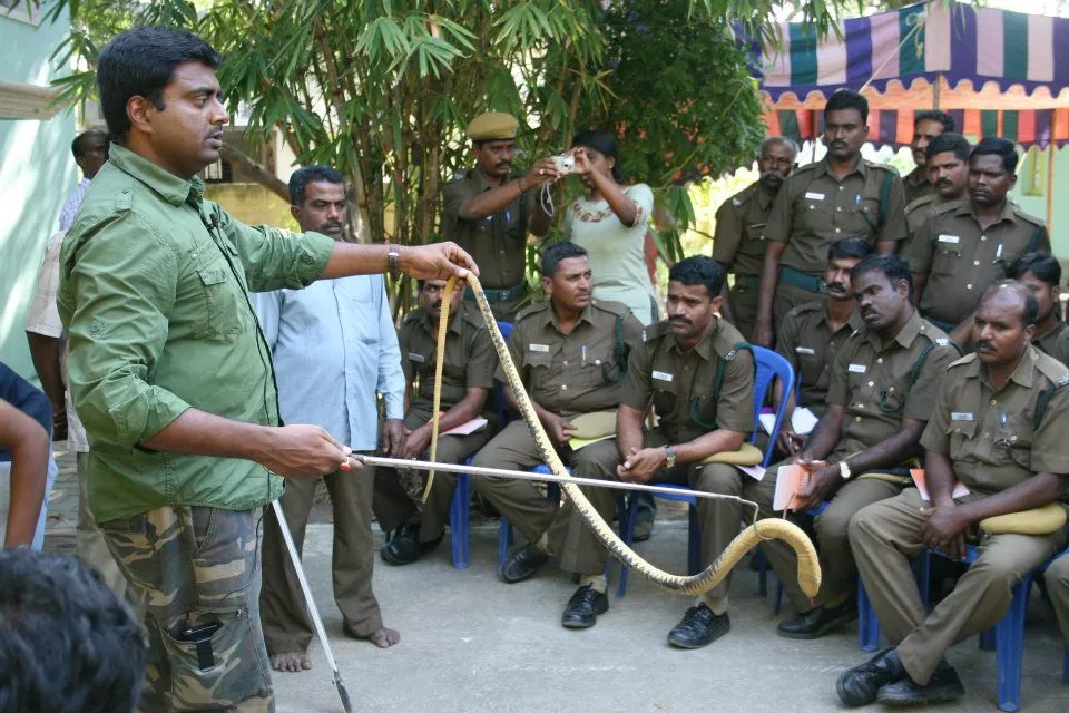 Vanamitra gives training to security guards to rescue snakes safely.