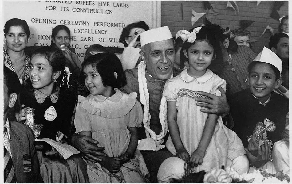 Jawaharlal Nehru sharing a light moment with kids.