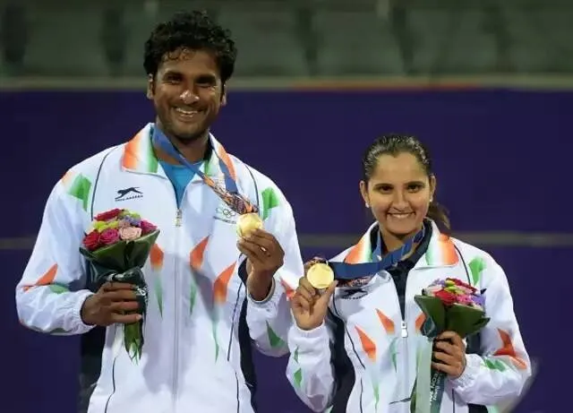 Gold medallist India's Sania Mirza (R) with Saketh Sai Myneni at the medal ceremony.