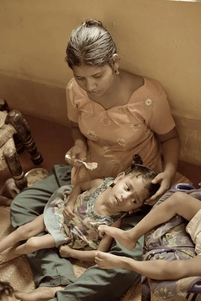 A mentally retarded person is slow to learn and may have physical handicaps such as speech impairment, visual impairment, hearing defects, or epilepsy. In this case the child sleeps most of the time and is incapable of moving her body much. She responds positively to whispers in her ear and eats very little. Care taking requires patience and hope more than anything else.