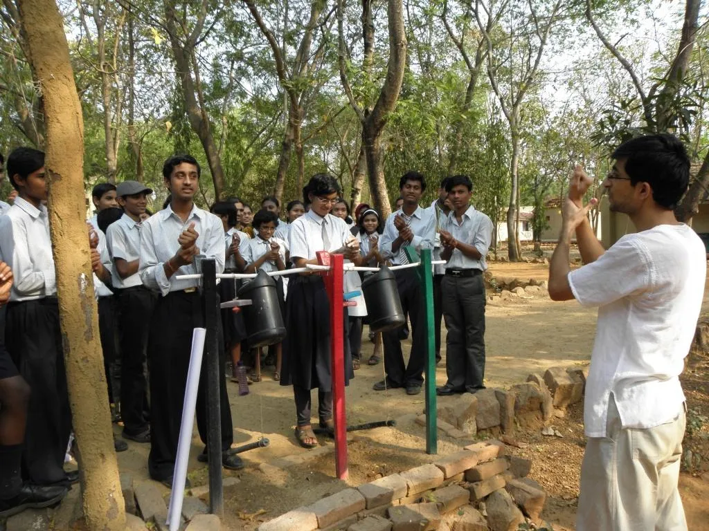 Pawan teaching the kids a song to wash their hands clean