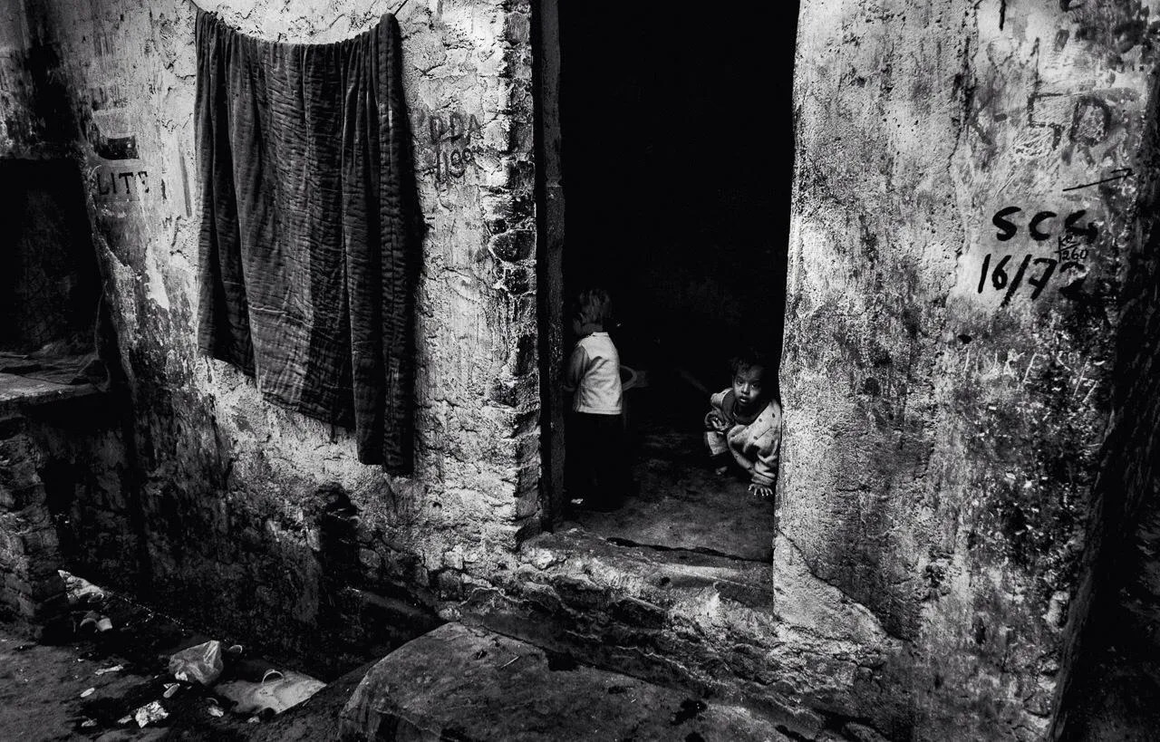 Kids looking out of their homes in the garbage dumps 