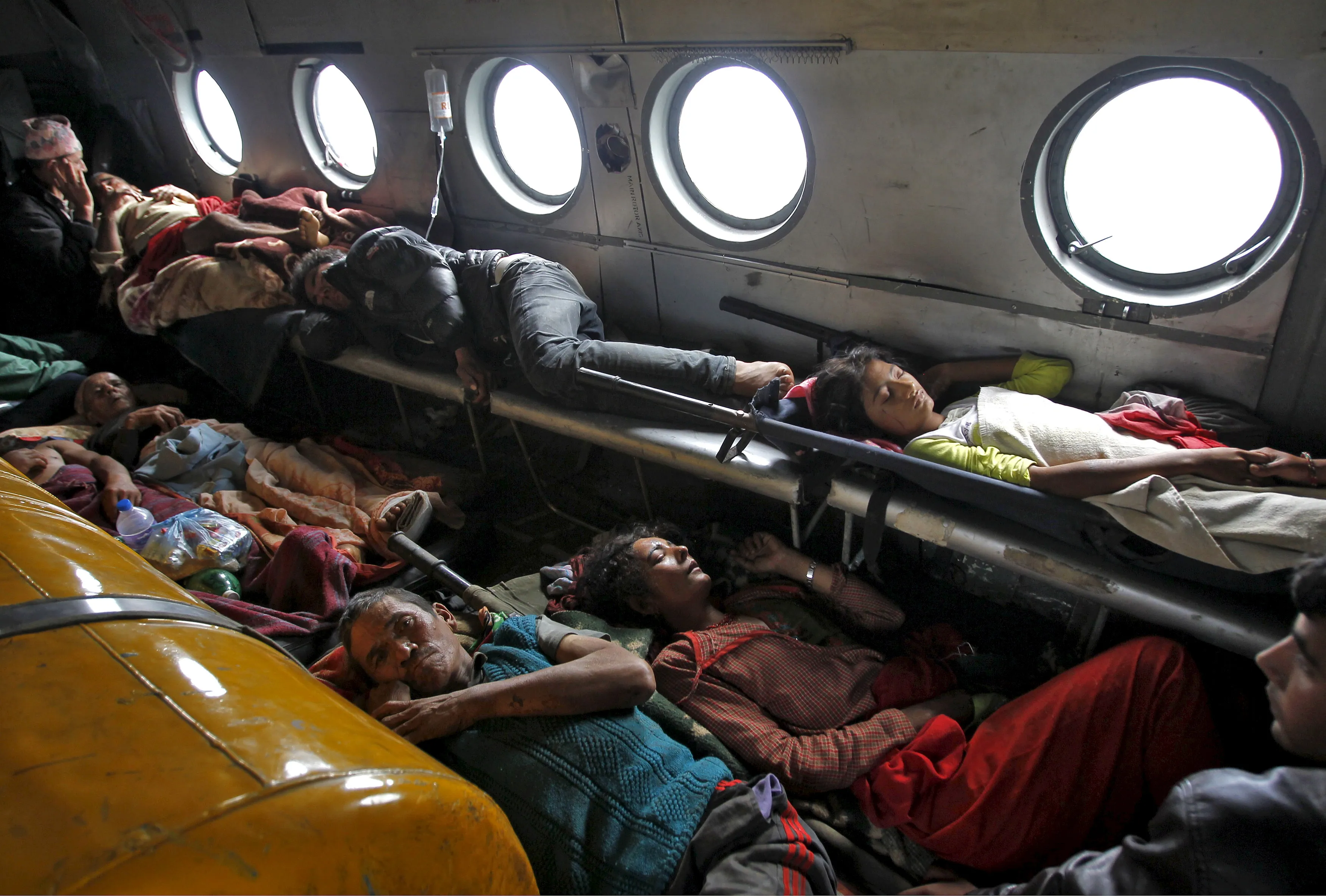 Victims of Saturday's earthquake lie inside an Indian Air Force helicopter as they are evacuated from Trishuli Bazar to the airport in Kathmandu, Nepal, April 27, 2015. REUTERS/Jitendra Prakash   - RTX1AH8L