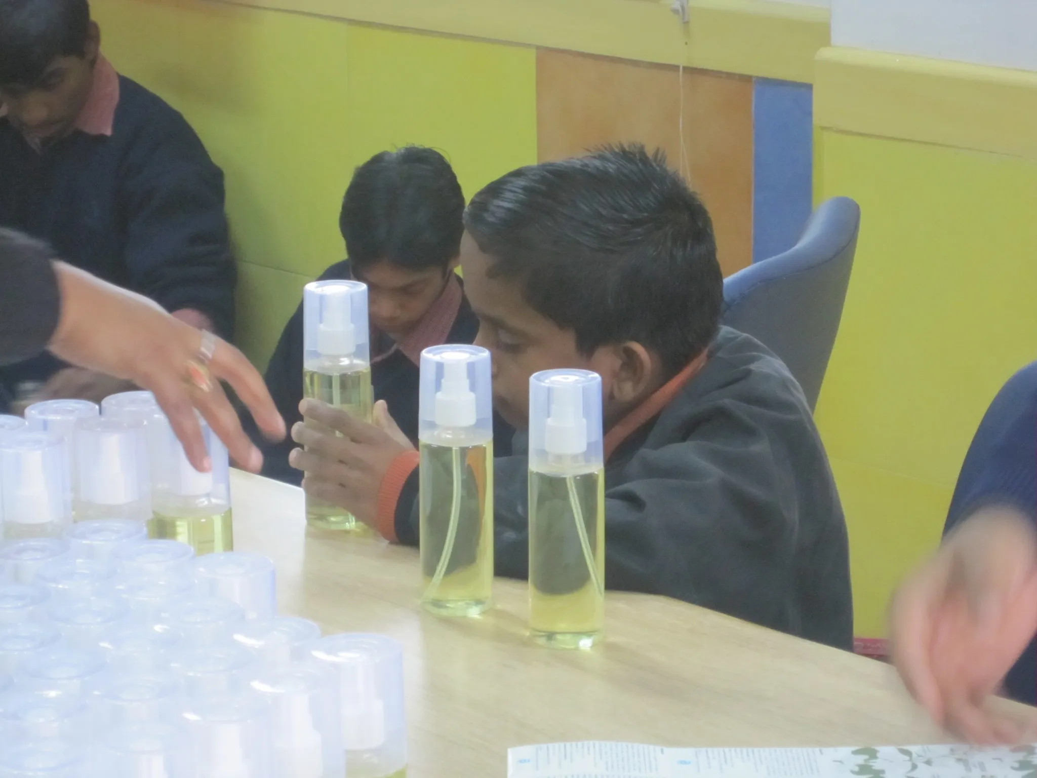 A group of children excitedly pack room fresheners into boxes. (Credit: Naunidhi Kaur\WFS)