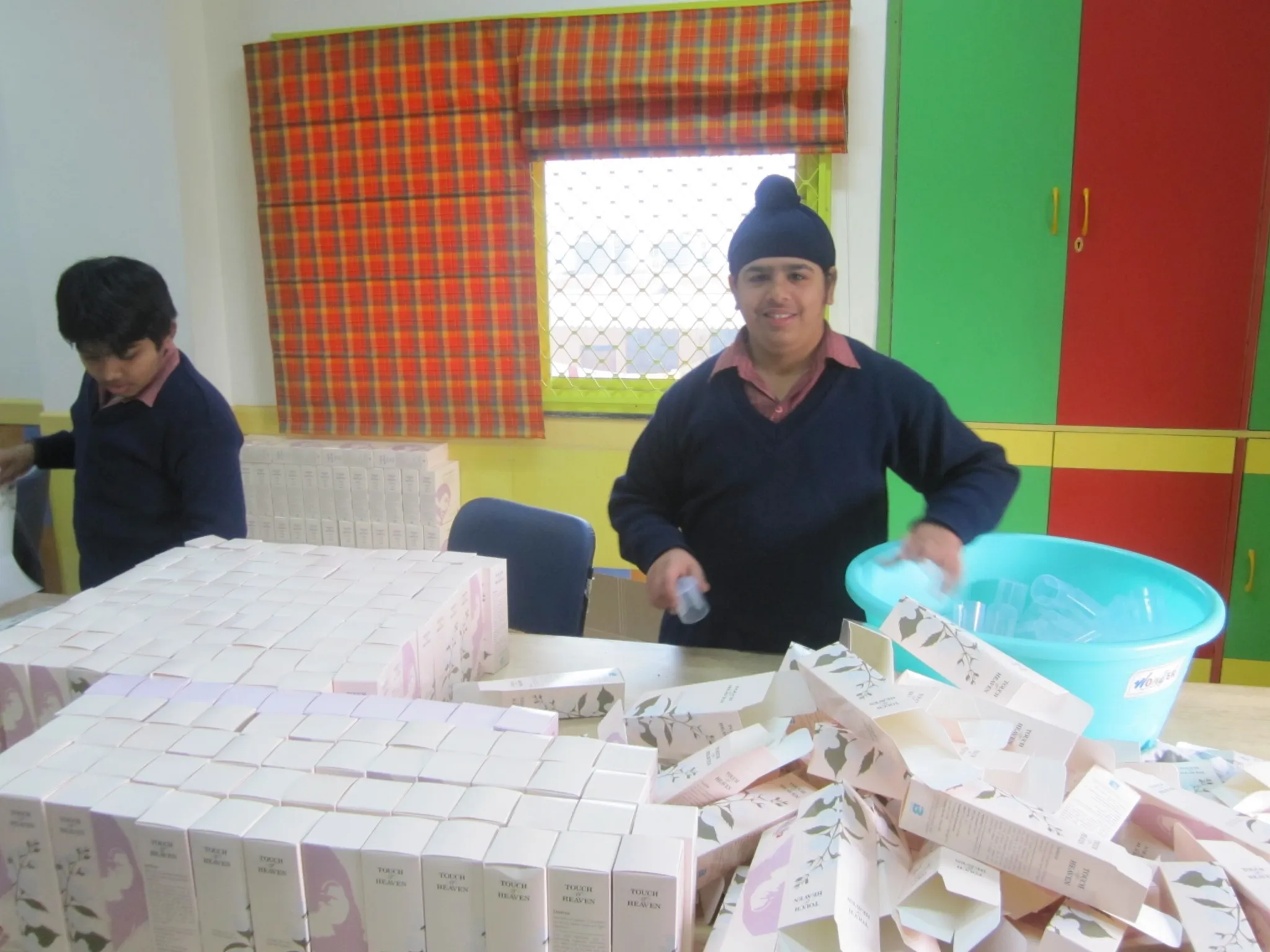 The packaging process for the air fresheners has been divided into small tasks that are repetitive and easy to handle. (Credit: Naunidhi Kaur\WFS)
