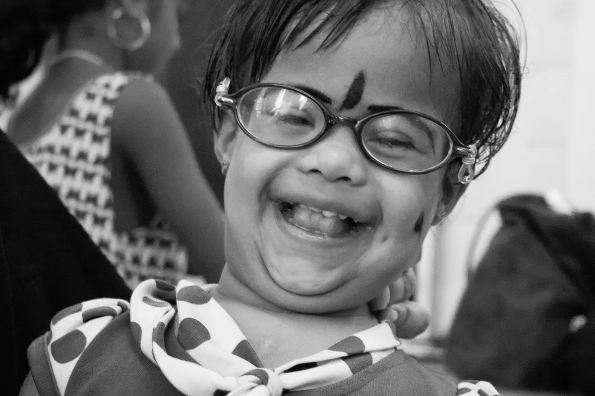One of many patients at the Thursday clinic, beams at a finger puppet.
