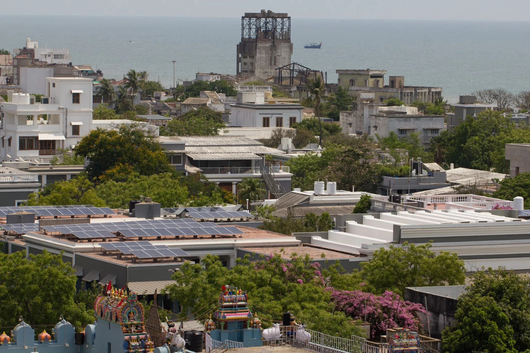 A bird’s-eye-view photo of the solar panels installed on SAICE rooftop with the Indian Ocean in the backdrop 