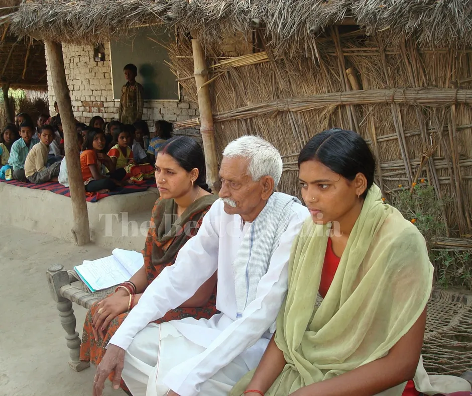 Gudiya, along with her father, Babu Lal Sharma, and sister, Soni, outside the school that is run from the verandah of their home. (Credit: Anjali Singh\WFS)