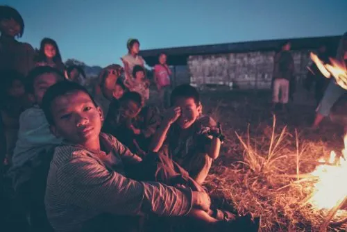 Children of the Chief and the villagers, hanging out by the bonfire in the church grounds of Longwa, a remote Konyak Naga village situated on the Indo-Myanmar border