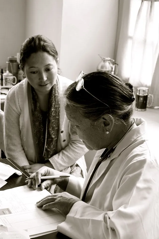 Dr Tsering Landol writing a prescription. (Source: Facebook/T Chosgyal Lharjey)