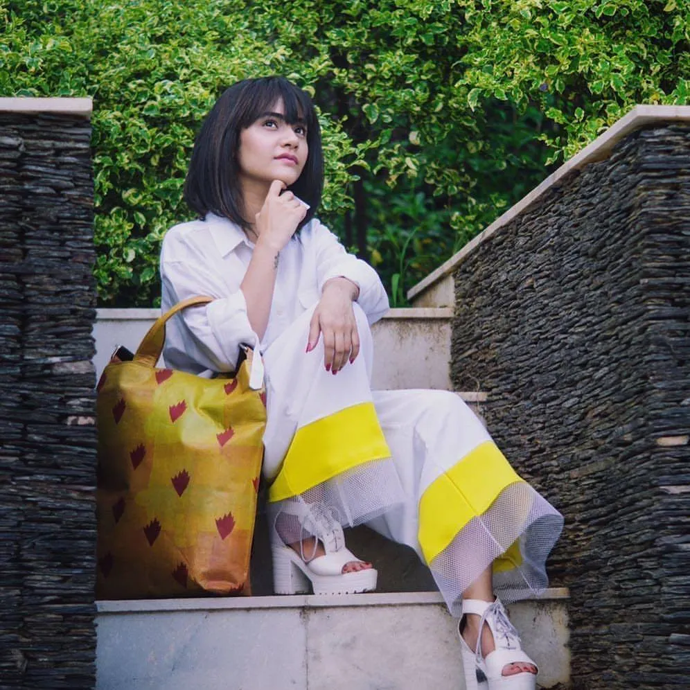 A yellow tote by Lifaffa. Plastic waste