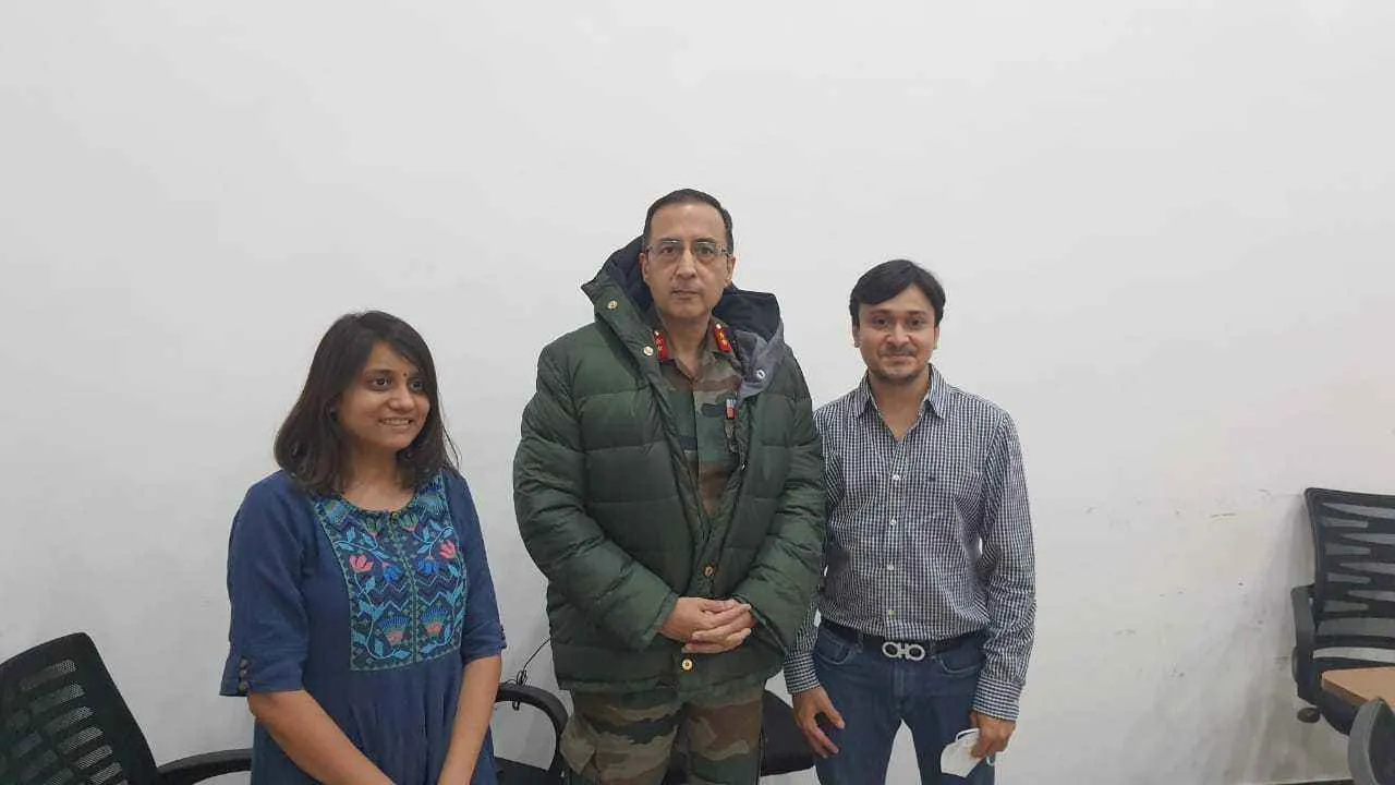 Khushboo and Neel presenting the jacket to the army personnel