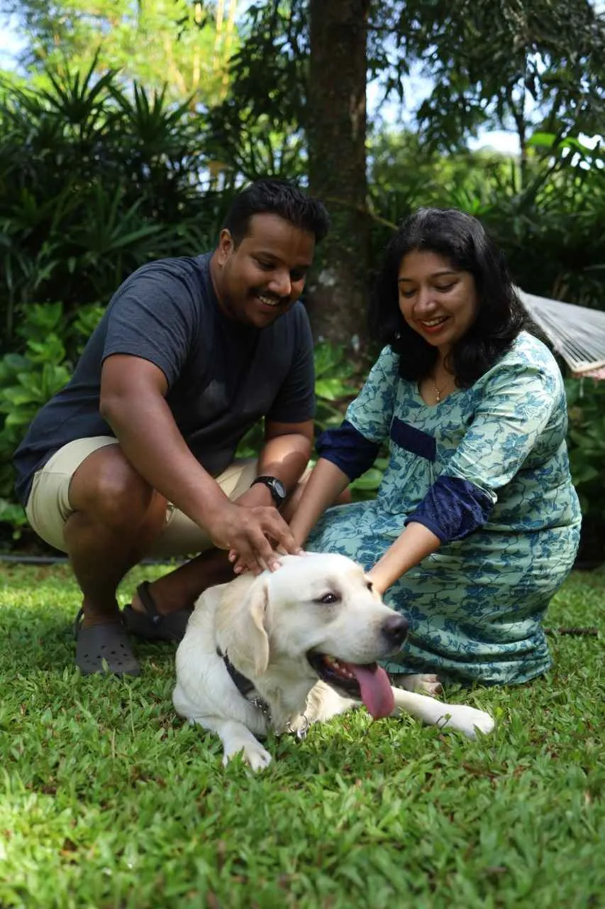 The couple with their pet Koffi, who guides the tourists around the place