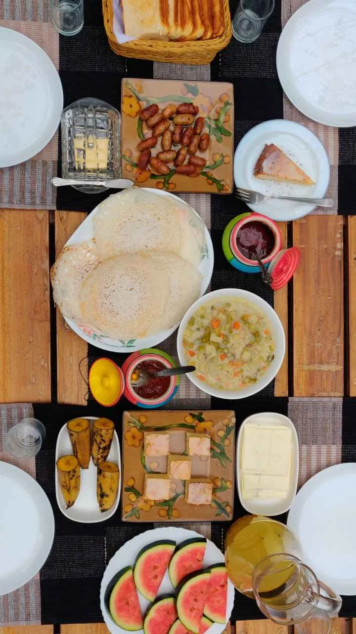 A feast at Vanilla County includes Kerala delicacies, curries, appams, and paani (a traditional drink made from toddy)