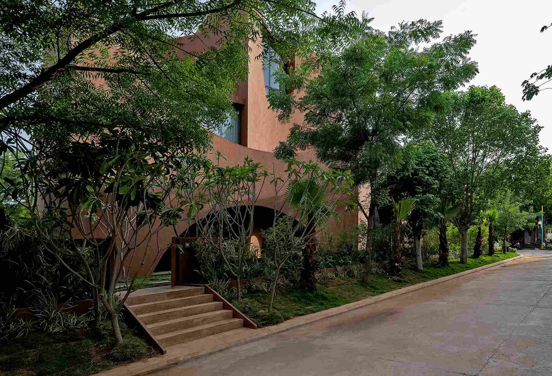 The northern and western sides have more open spaces with garden areas and existing trees