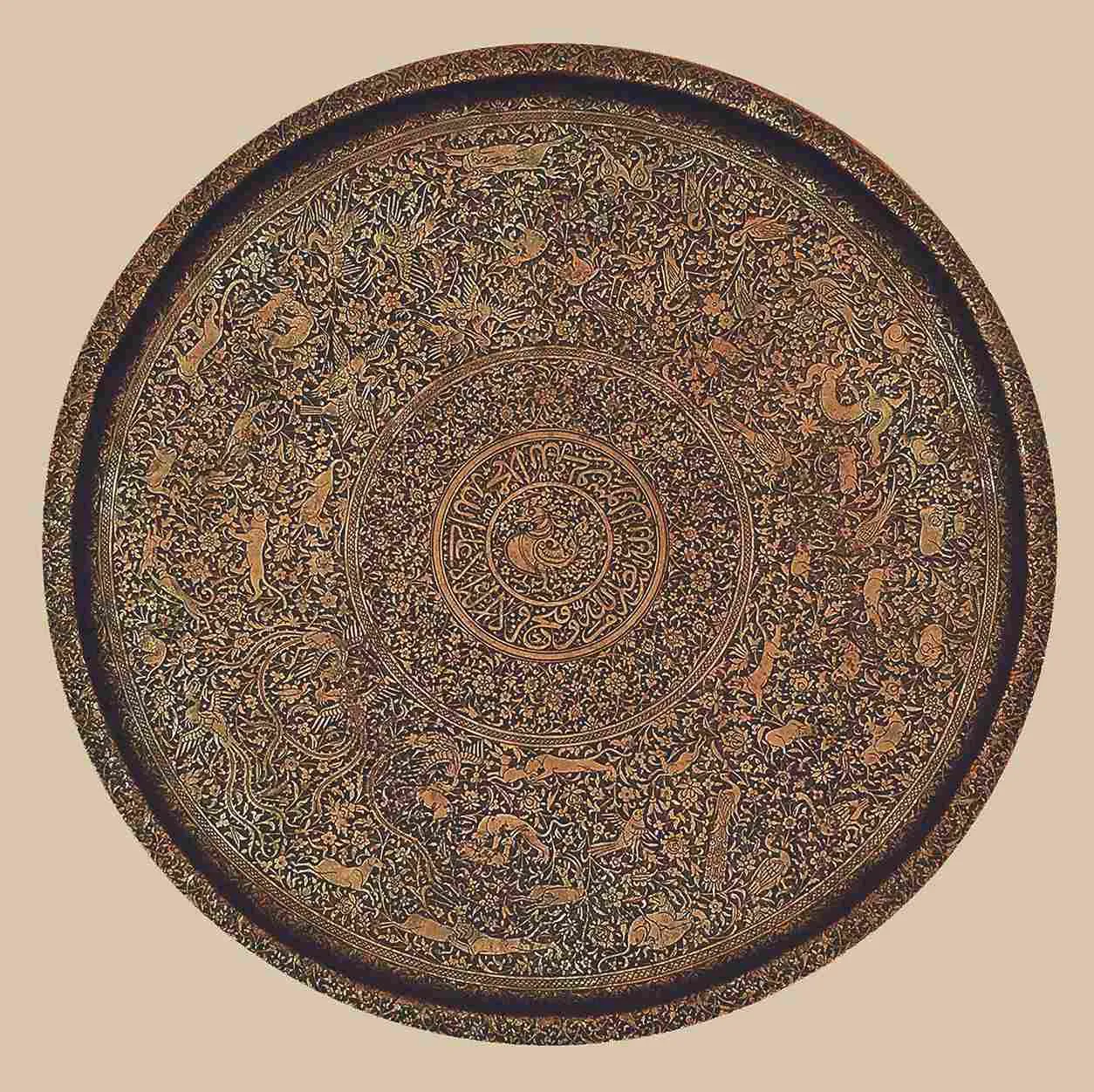 Circular salver (thali) with animals and birds amid animated floral arabesques<br />
copper