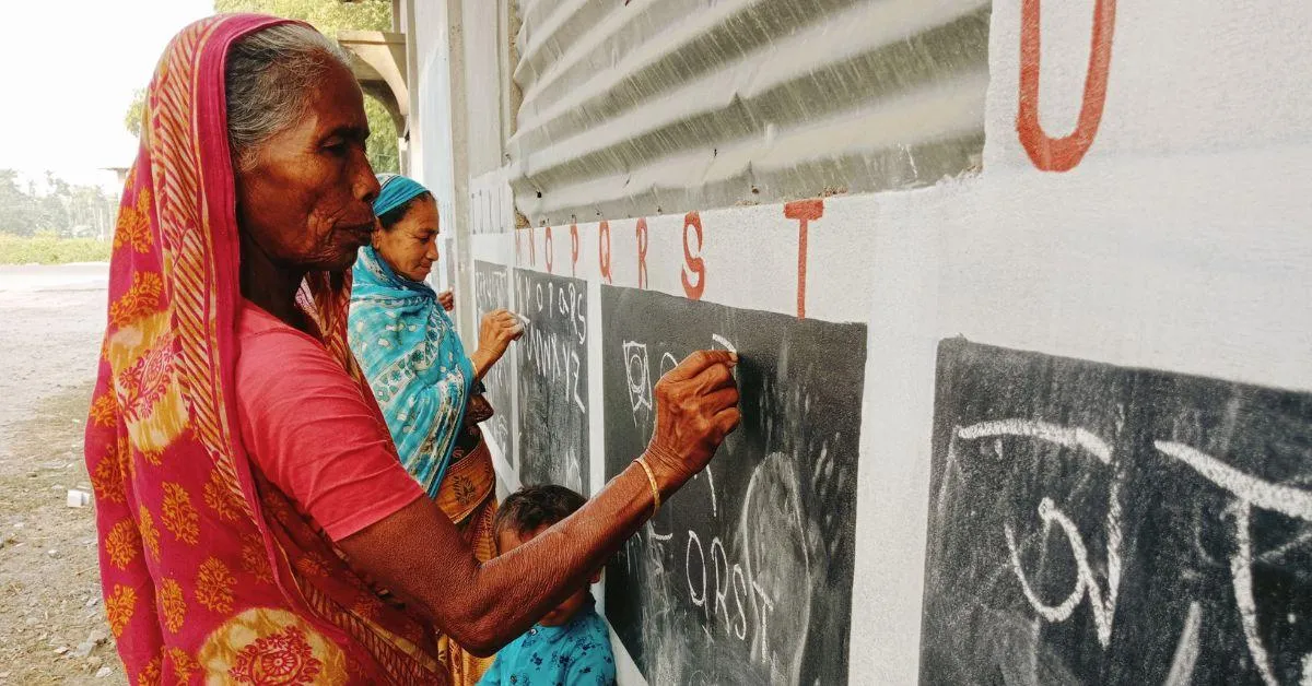 A girl teaching her grandmother to write