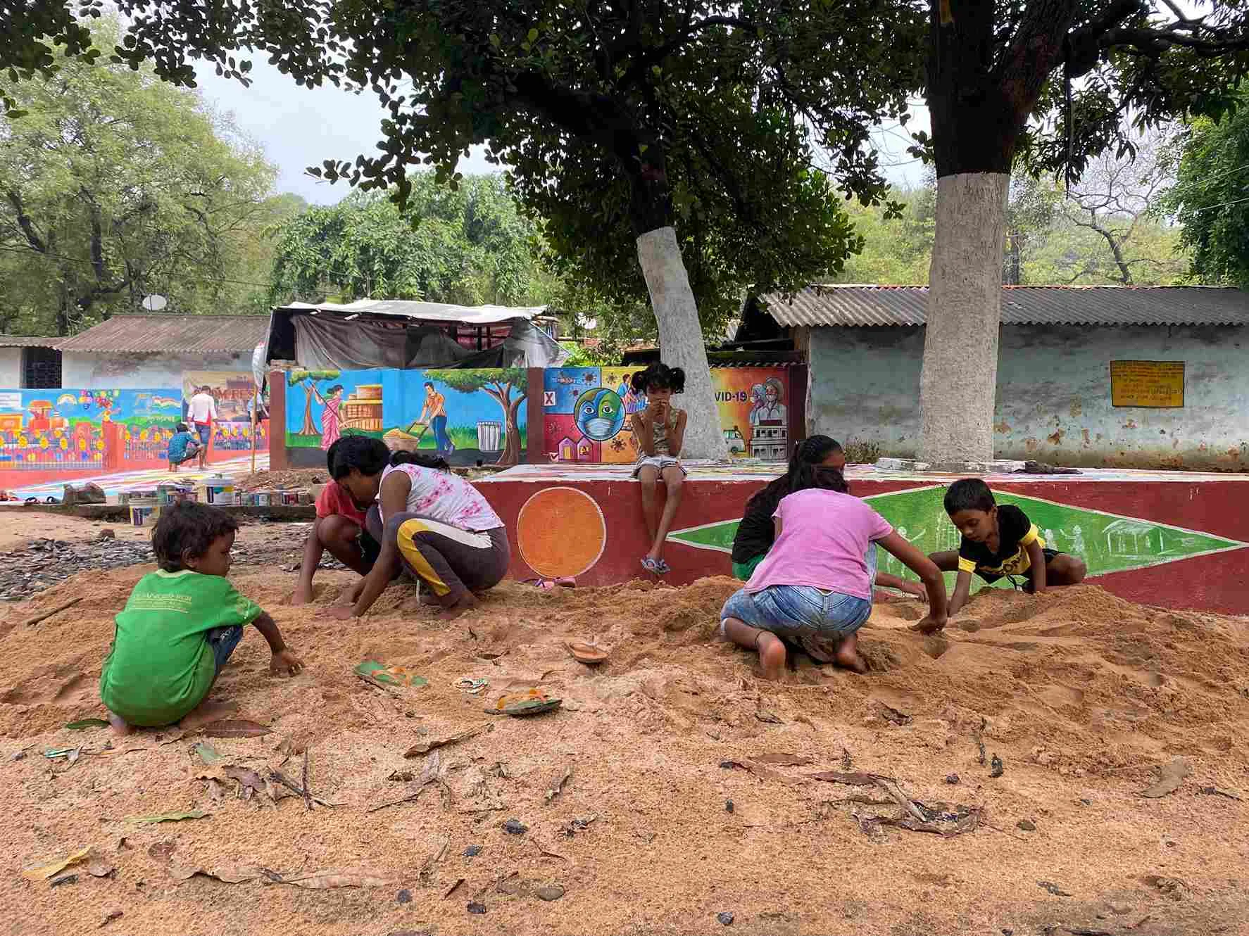 Children playing in the sandpit near the temple in Leprosy Pada.