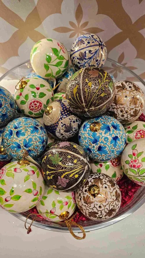 Handcrafted paper mache baubles from Kashmir, radiating colour and artistry in every brushstroke